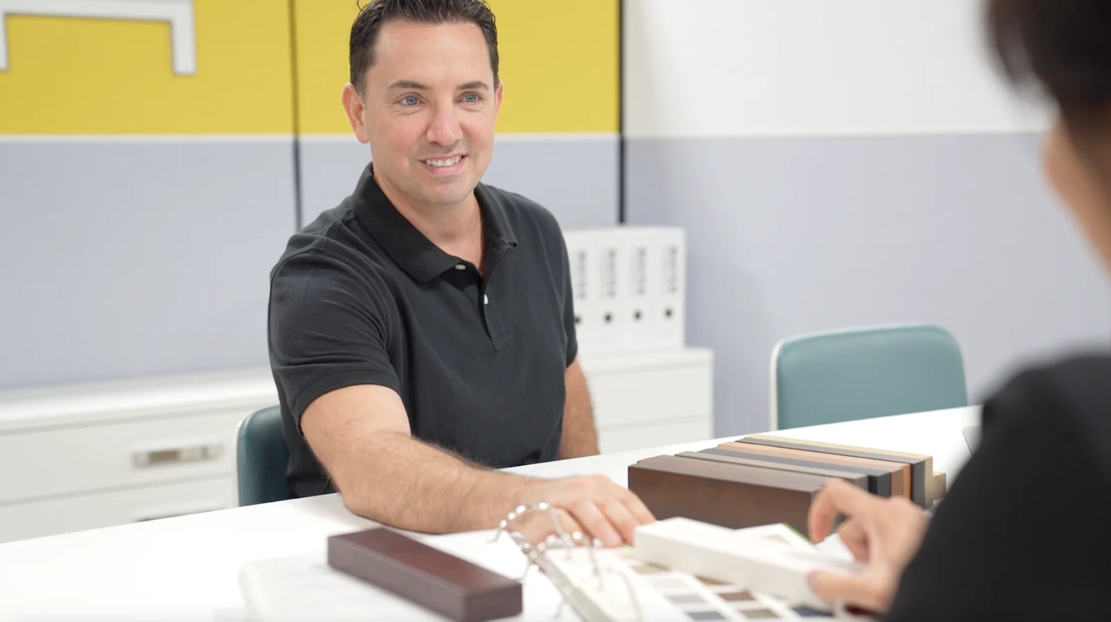 Mark, HVOF sales rep, reviewing finish samples with a client at the showroom